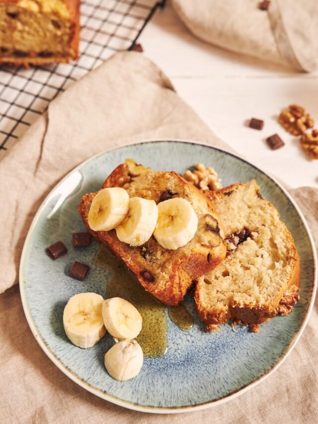 Vertical shot of slices of delicious banana bread with chocolate chunks and walnut on a plate